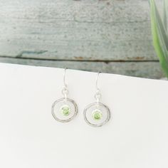 "August Birthstone Earrings, Peridot Jewelry, August Birthday Gift, August Birthstone Jewelry, August Peridot Earrings, Sterling Silver Lovely August Birthstone Peridot Earrings. Peridot is the light yellow-green birthstone of August and it is one of my favorite of the gemstones. Like diamonds, these gems are formed deep inside the mantle of the Earth. They are brought to the surface through tectonic and volcanic activity. In Hawaiian mythology, the gemstone is considered the \"tears\" of the fi Lime Green Birthstone Jewelry For Gifts, Lime Green Birthstone Jewelry Gift, Lime Green Peridot Gemstone Earrings, Peridot Drop Earrings For May Birthstone, Peridot Lime Green Earrings As Gift, Peridot Earrings In Lime Green As A Gift, Green Peridot Earrings For Anniversary, Peridot Lime Green Earrings For Gift, Peridot Dangle Earrings Gift