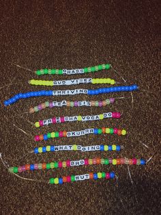 four different colored toothbrushes are arranged in the shape of an x with words on them