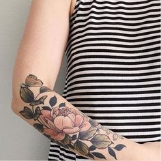 a woman's arm with flowers on it and the words, i want to post a recent photo or video?