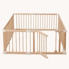 a baby gate that is made out of wood and has bars on each side to keep it from falling