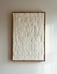 a white wall with a brown frame on it