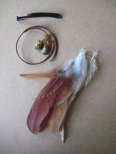 an assortment of feathers and other items laid out on the floor