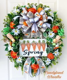 an orange and white wreath with the word spring on it