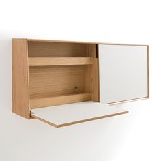 an open wooden cabinet on the wall with white paper in it's bottom compartment