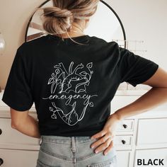 a woman standing in front of a mirror wearing a black t - shirt with the words love and energy written on it