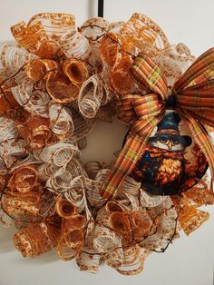 a wreath made out of old book pages with an image of a cat on it