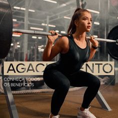 a woman squats with a barbell in front of her