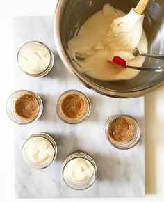 the ingredients are being mixed together in small glass bowls on top of a marble table