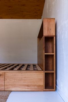 the bed is made up and ready to be used as a storage unit for books