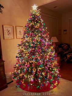 a brightly lit christmas tree in a living room