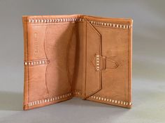 an open brown leather wallet on a white surface with no one in the photo inside