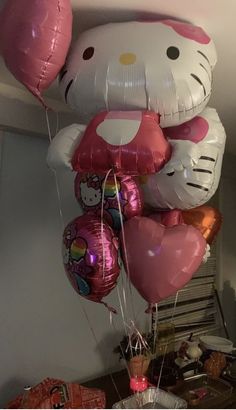 hello kitty balloons are hanging from the ceiling