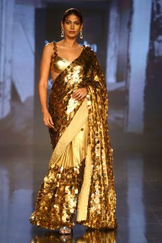 Gold saree with all-over sequin embroidery. Comes with sleeveless blouse and petticoat.
Component: 3
Pattern: Embroidery
Type Of Work: Sequin
Neckline: Sweetheart
Sleeve Type: Sleeveless
Fabric: Foil Georgette
Color: Gold
Other Details: 
Shoulder straps with sequin embroidery
Occasion: Wedding - Aza Fashions Gold Saree, Embroidered Saree, Gold Blouse, Sequin Embroidery, Luxury Sale, Pattern Embroidery, Blouse For Women, Sequins Embroidery, Buy Gold