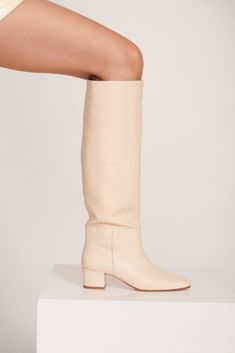 The Nancy is the epitome of the classic 60s knee high boot. The wider shaft and the slightly-square-but-round toe shape to give a vintage rainboot silhouette. Super comfy and cool for all occasions. Cream Knee High Boots, Heel Accessories, Mule Sandals, Goat Leather, Flat Boots, Denim Flares, Sneaker Heels, Fashion Books, Cow Leather