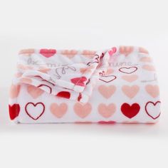 a pink and red blanket with hearts on it