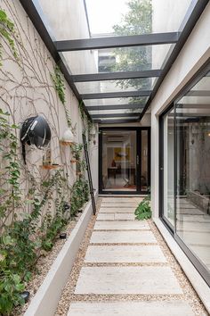 the walkway is lined with plants and rocks, leading to an outdoor living room area