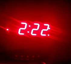 a red clock with the time 535 on it's face is lit up