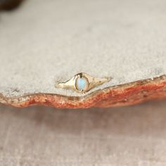 A small oval opal ring is set with prongs on an organically crafted 14k gold band. Ring Stack, Ocean Conservation, Crystal Opal, Fairy Godmother, Opal Ring, Opal Crystal, Godmother, Moon Stone, Organic Shapes