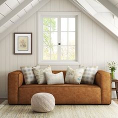 a living room filled with furniture and a white rug on top of a wooden floor