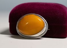 "Vintage Sterling Silver Cabochon 28mm Egg Yolk Amber Pin Brooch - C Clasp 10.1g The early silver pin tested as sterling silver. Nice chunky Egg Yolk amber free form stone. There is a hallmark on the pin section Brooche's size is 1 1/4\" by 1 1/8\"" Oval Cabochon Brooches For Anniversary, Silver Hallmarked Oval Brooch, Silver Hallmarked Oval Brooches, Silver Oval Hallmarked Brooch, Silver Oval Brooches Hallmarked, Classic Cabochon Brooches For Gifts, Classic Cabochon Brooches As Gift, Classic Oval Brooches For Collectors, Classic Oval Silver Brooches