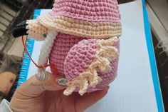 a crocheted stuffed animal wearing a pink hat