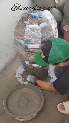 a young boy is working on some pottery