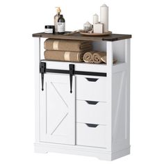 a white cabinet with drawers and towels on top of it's doors, next to a bottle of wine