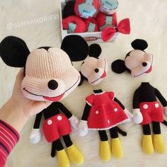 crocheted mickey and minnie mouses are on the table with their stuffed toys