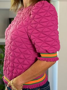 Get ready to stand out with the Color Pop Quilted Pullover! This fun, textured piece brings a bold twist to classic comfort with its unique design and eye-catching details. DETAILS Design: Quilted knit pullover in vibrant pink with bold orange and green stripe details around the sleeves and waist. Features: Round neckline with short puff sleeves, giving it a playful and feminine touch. It sits at the waist for a flattering and easy-to-wear silhouette. Trim: Striped band details at the hem and cu Quilted Pullover, Orange And Green, Dress Jewelry, Knit Pullover, Fall Shopping, Green Stripes, Knitted Pullover, Puff Sleeves, Round Neckline