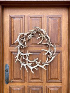 a wooden door with antlers on it