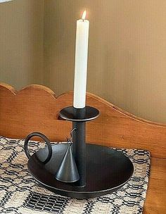 a lit candle is sitting on a black plate