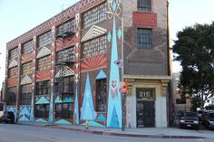 an old building painted with colorful designs on the side