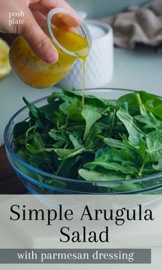 a person pouring dressing into a bowl filled with spinach