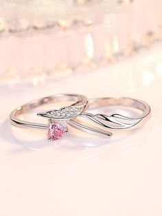 two silver rings with pink and white diamonds