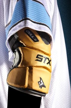 a close up view of a hockey goalie's gloves and arm guards, with the number six on it