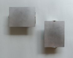 two square shaped objects on a white surface