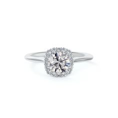 a white gold engagement ring with an oval diamond center