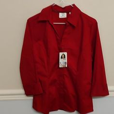 Rider Lee Women's Red Button Down Blouse With 6 Hidden Buttons & A 3/4 Sleeve With Notched Cuffs And V-Neck. New With Tag. Efferless Care. Gwb. Red Office Shirt With Button Closure, Red Workwear Blouse With Button Closure, Formal Blouse With 3/4 Sleeves And Button Closure, Red Buttoned Blouse For Work, Red 3/4 Sleeve Tops For Work, Red Workwear Blouse With Buttons, Red Blouse With Buttons For Work, Red Formal Blouse With Button Closure, Red Blouse For Office Wear