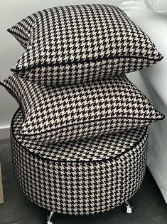 three black and white pillows stacked on top of each other