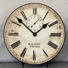 a wooden clock with roman numerals and the words wallham primer on it