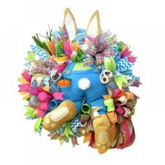 a blue stuffed animal with lots of colorful ribbons on it's head and legs