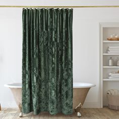 a bath tub sitting next to a shower curtain