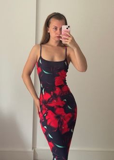 This black and red hibiscus maxi dress is perfect for those who love a 90s model vibe. The dress is designed to hug your curves and show off your shape in a figure hugging body con style. The dress features strappy detailing with a scoop neckline, adding an extra touch of femininity. It's perfect for any special occasion, whether it's a holiday, beach day or birthday celebration. The tropical Hawaiian hibiscus print adds an exotic touch to the dark feminine style of the dress. With its stretchy Fitted Summer Maxi Dress For Night Out, Red Floral Print Bodycon Dress, Fitted Red Floral Print Bodycon Dress, Red Fitted Midi Dress For Vacation, Fitted Sleeveless Maxi Dress With Tropical Print, Red Fitted Bodycon Dress For Beach, Red Fitted Bodycon Beach Dress, Party Tropical Print Maxi Sundress, Party Sundress With Tropical Print