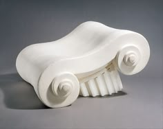 a white plastic chair that is shaped like a car