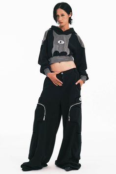 The Bat Patchwork Cropped Hoodie stands at the intersection of casual comfort and avant-garde style. This piece features a distinctive patchwork design on the front that resembles a bat, setting a bold and playful tone. Central to the hoodie is the brand's logo, anchoring the design with a sense of identity. The shoulders are enhanced with fabric that mimics the look of armor plating, adding an edge of sophistication and strength to the overall silhouette. The hoodie is designed with tightened h Pattern Brands, Avant Garde Fashion, Patchwork Patterns, Patchwork Designs, Accessories Branding, Cropped Hoodie, Logo Branding, Snug Fit, Brand Logo