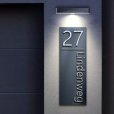 an illuminated sign on the side of a building that says twenty five eleven twelve seven