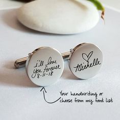 two personalized cufflinks with handwriting on them