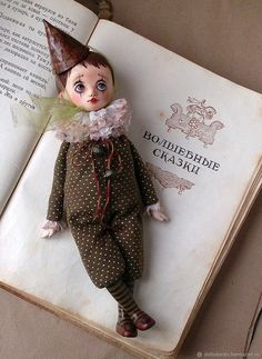 an open book with a doll on it