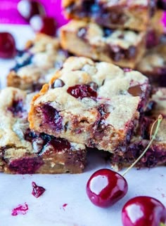 chocolate chip and cherry blondies are stacked on top of each other with cherries