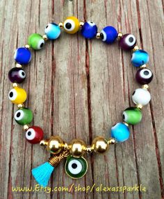 This beautifully handmade bracelet is made of round medium sized glass eye beads that are multicolors. They are made with elastic string and Multicolor 8mm Beads Evil Eye Bracelet, Spiritual Multicolor Round Stretch Bracelet, Adjustable Multicolor Evil Eye Bracelet With 8mm Beads, Adjustable Multicolor Evil Eye Beads, Multicolor Beaded Evil Eye Bracelet Spiritual, Multicolor Beaded Evil Eye Bracelet, Bohemian Multicolor Round Beads Evil Eye Bracelet, Spiritual Multicolor Stretch Bracelet With 8mm Beads, Adjustable Evil Eye Bracelet With Colorful Beads